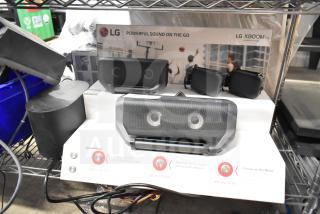 LG store display with XBOOM Go speakers, featuring clear branding. Includes multiple speaker models. Good condition.