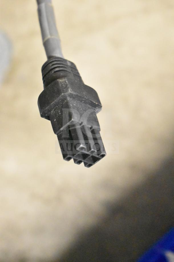 Close-up of a black electronic cable connector, part of a lot including Vizio SV510XW-0906 Subwoofer, Sensormatic ZBSMPROE Antenna Deactivator.