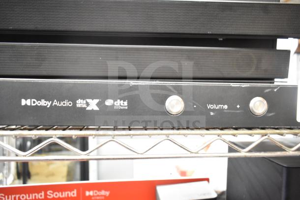 Samsung store display with sound bar, featuring Dolby Audio and dts:X logos, volume controls, in good condition.