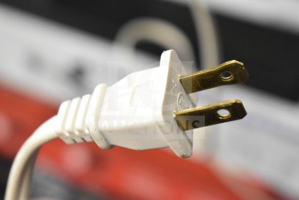 White power plug for Vizio Store Display with Cinema Surround Sound Bar, showing brass prongs and a textured grip.