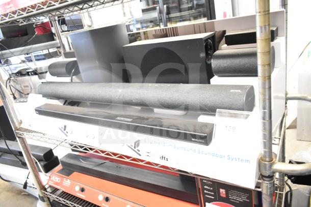 Onn store display featuring speakers and sound bar, 5.1 channel ultra-slim surround system, with visible brand labels.