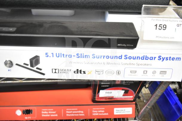 Onn store display with speakers and sound bar, showcasing 5.1 ultra-slim surround soundbar system, Dolby Atmos, DTS:X support.