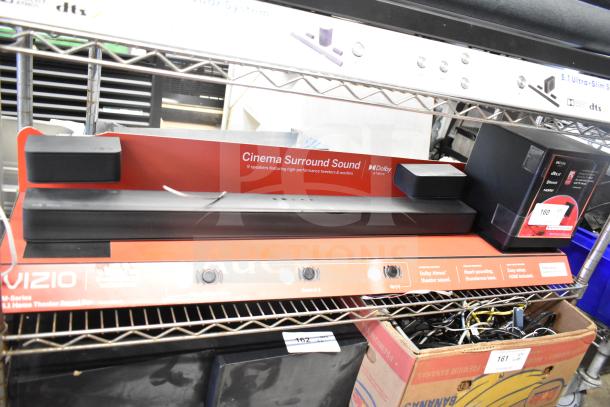 Vizio store display with sound bar featuring Dolby Atmos, showcasing Cinema Surround Sound. Includes controls and HDMI setup info.