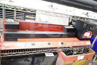 Vizio store display with sound bar featuring Dolby Atmos, showcasing Cinema Surround Sound. Includes controls and HDMI setup info.