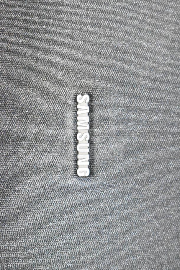 Samsung PS-WB65D wireless subwoofer, textured grey fabric, Samsung logo visible, excellent condition.