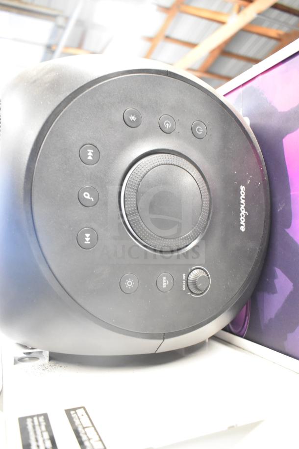 Soundcore electronic unit with control panel; features power, volume, and mode buttons, in gently used condition.