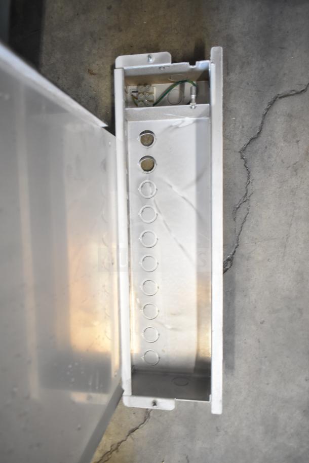 Metallic store display base with wiring and perforated design, possibly part of Rave+ display set. Condition appears used.