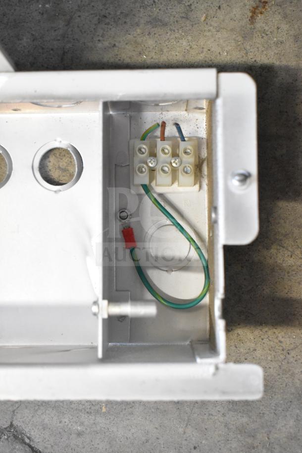 Metallic enclosure with wiring, featuring terminal block and exposed wires; part of Rave+ store display and electronic units.