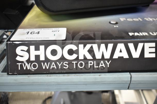 Shockwave store display with two speakers, "Two Ways to Play" text, slightly worn packaging, tag for PCI Auctions.