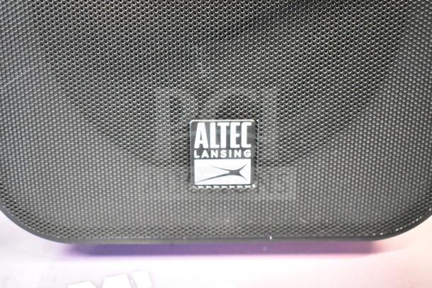 Altec Lansing Shockwave store display with two speakers, mesh grille, brand logo visible, in good condition.