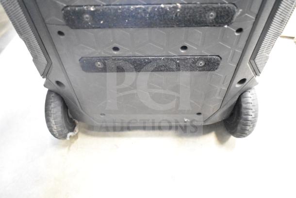 Monster Speaker with sturdy wheels and textured base. Minor wear visible. Designed for portability and durability.