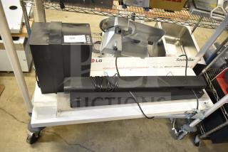 LG store display with sound bar and two speakers, includes packaging. Features visible cables, good condition.