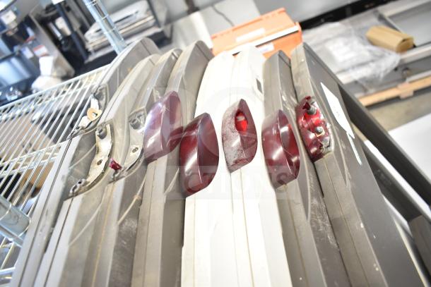 Eight Sensormatic antitheft detectors, dusty, with red sensors, used condition; multiple units shown.