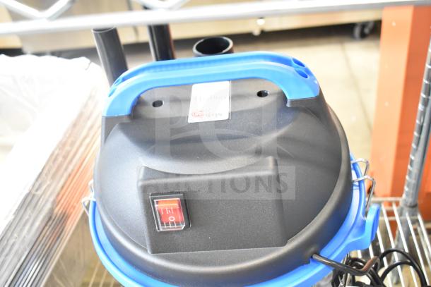 BRAND NEW Lavex 944BJ1235G 5 Gallon Stainless Steel Wet/Dry Vacuum, 100-120V, with toolkit, top view showing power switch.