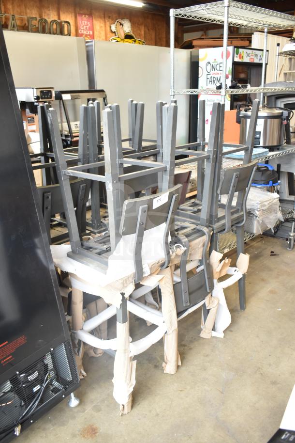12 new bar height chairs with wood-pattern seats and metal frames, labeled, in packaging, scratch and dent condition.