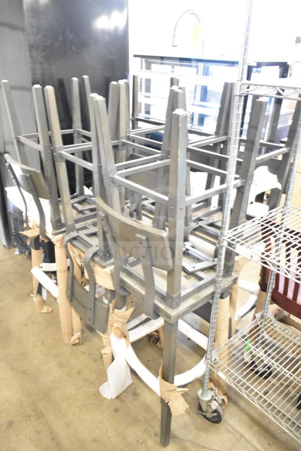 12 new bar height chairs with wood-pattern seat/back, metal frame. Scratch and dent condition. Chairs stacked in storage.