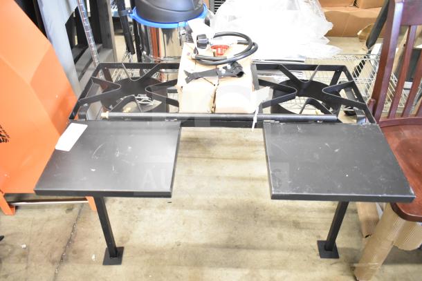 Brand new 2-burner propane range, scratch and dent. Features two black burners, support legs, and attached side shelves.