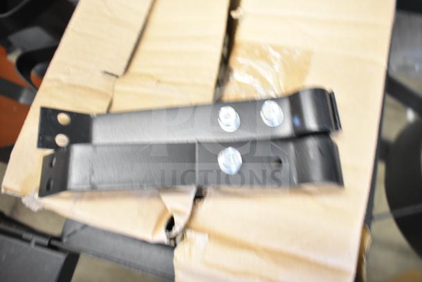 New 2-burner propane gas range with scratch and dent marks, includes metal brackets, partially visible on cardboard.