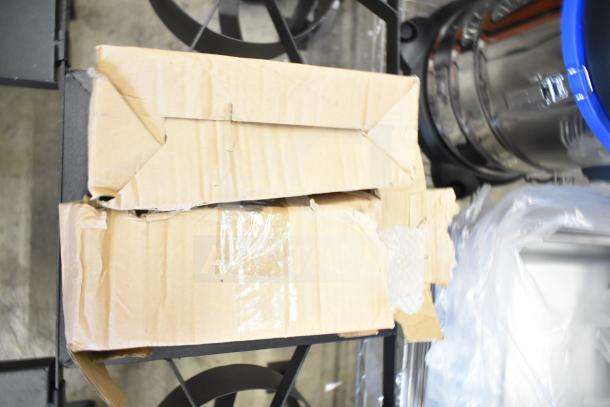 Damaged box containing a brand new 2 burner propane gas range, scratch and dent condition, with no visible labels.