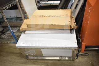 BRAND NEW ServIt 423EST2WSPB Two Pan Electric Steam Table with dents, partially enclosed base, 120V, 1 Phase. Box labeled "Left Apron & Right Apron."