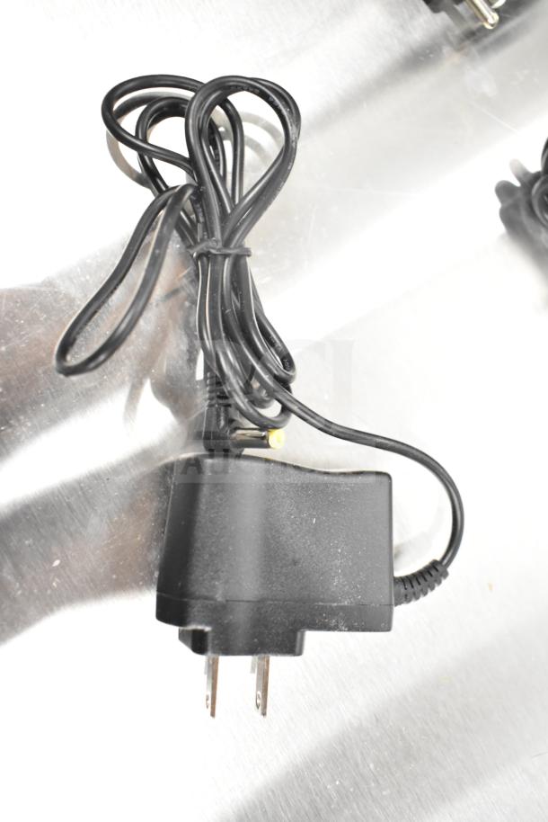 Power adapter for Torrey L-PC-40L, scratch and dent condition, black with attached cable and plug.