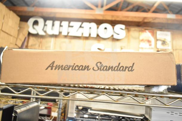 American Standard faucet box on a shelf, labeled "American Standard," indicating new item condition.