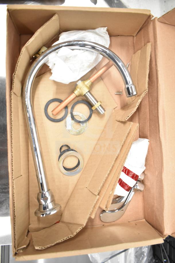 Two boxed, scratch and dent faucets: American Standard Monterrey and T&S B-1141-04, new condition with components.
