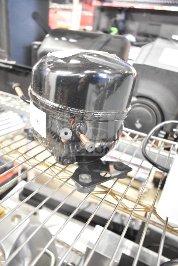 BRAND NEW SCRATCH AND DENT! Cubigel NUT70NR Avantco 17817638 Compressor. Visible minor marks, mounted on wire shelf.