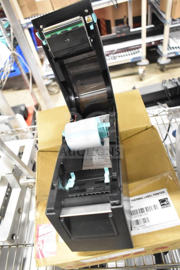 BRAND NEW GoDex DT2x Thermal Label Printer, scratch and dent, open view showing roll. Box label confirms model and condition.