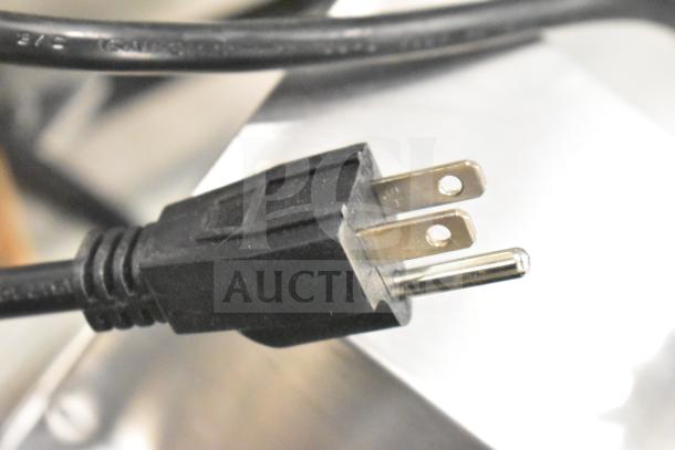 Close-up of a power plug for the Carnival King 382WSM22 Double Waffle Maker, indicating a 120-volt electrical rating.