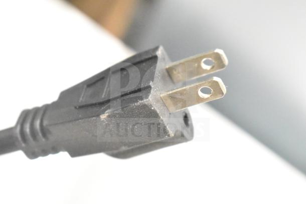 Close-up view of the plug from Carnival King 382WSM22 Double Waffle Maker, 120 Volts, showing prongs and slight surface scratches.