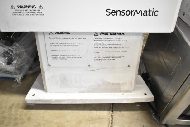 Sensormatic ZPUODPP-ENC-2 Outdoor Cabinet, white, with warning labels, restricted access notice, visible wear at base.