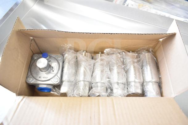 Box containing parts of Cooking Performance Group CPG Commercial Griddle, brand new with minor cosmetic flaws, wrapped in plastic.