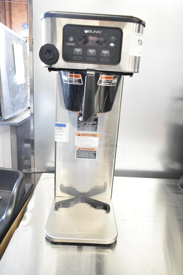 Brand new Bunn ICB-DV 53100.0100 BrewWISE Infusion stainless steel coffee brewer. Features digital display, dual brew spouts, and warning labels.
