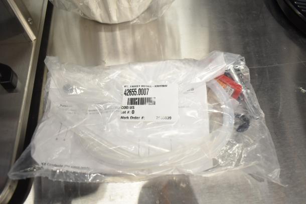Plastic bag labeled "Kit, Faucet Install" with part number 42655.0007, containing installation components and instructions.