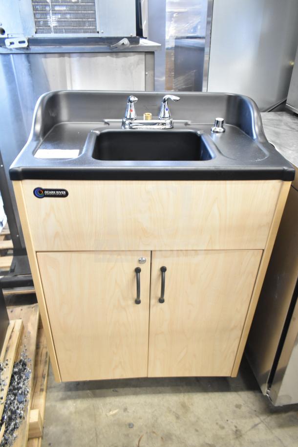 Brand new Ozark River ADSTM-AB-AB1N portable sink, scratch and dent, on commercial casters. Features wood cabinet, dual faucets.