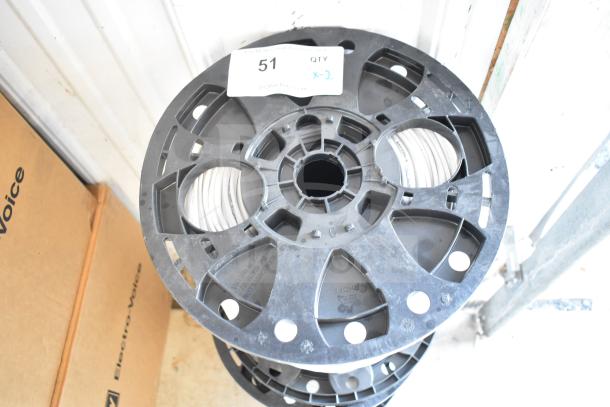 Two General Cable E3062S.41.86 12 gauge spools. Black plastic reels with visible white cable. Item tag reads "51 QTY x-2."