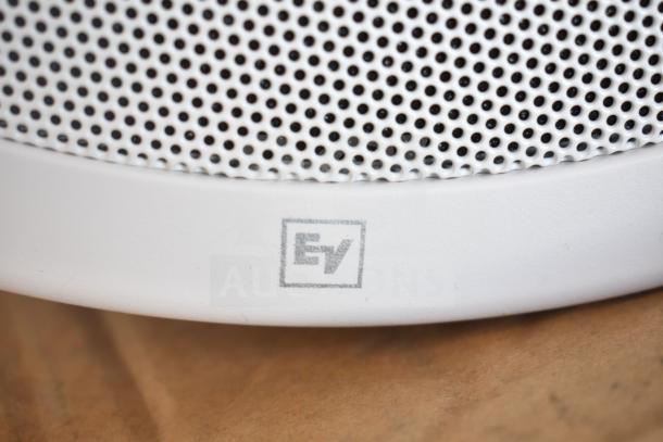 Close-up of Electro-Voice EVID-P6.2W speaker grille with EV logo, white finish, showing fine mesh details.