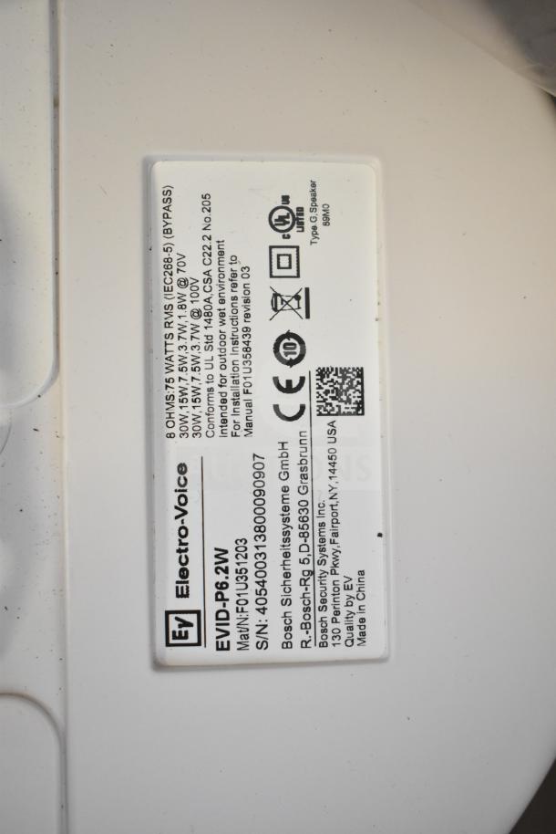 7 Electro-Voice EVID-P6.2W speakers; white, waterproof, for outdoor use. Labels detail model number and compliance certifications.