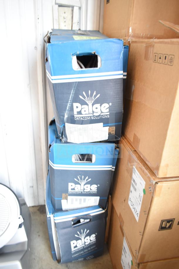 Three boxes of Paige Datacom Solutions 12/2C STR ZIP CL3 WHITE cable, new in box, stacked and labeled for auction.