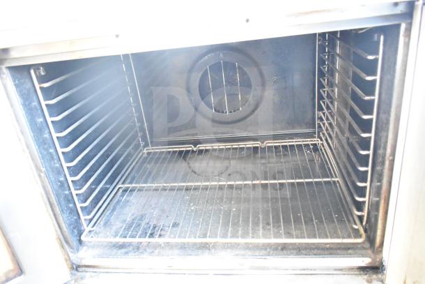 Blodgett Mark V commercial convection oven interior with racks, thermostatic controls, and clear view doors, on casters. Clean condition.