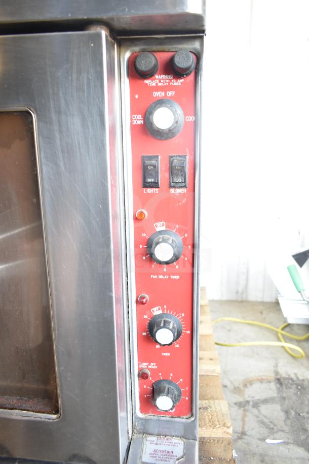 Blodgett Mark V electric convection oven with view-through doors, thermostatic controls, legs on casters, and control panel visible.