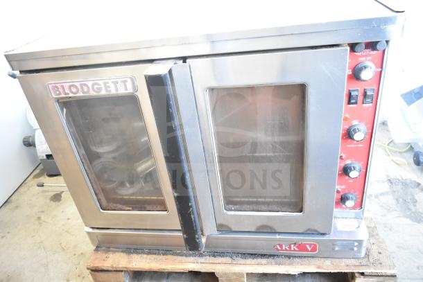 Blodgett Mark V commercial convection oven with view-through doors, thermostatic controls, and caster legs. Visible model and brand labels.