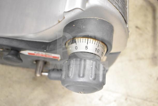 Hobart 2912 commercial meat slicer knob showing thickness settings. Adjustable, durable, and in used condition.