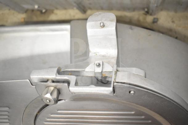 Hobart 2912 commercial meat slicer, 115 volts, 1 phase, close-up view of blade assembly, shows some wear.