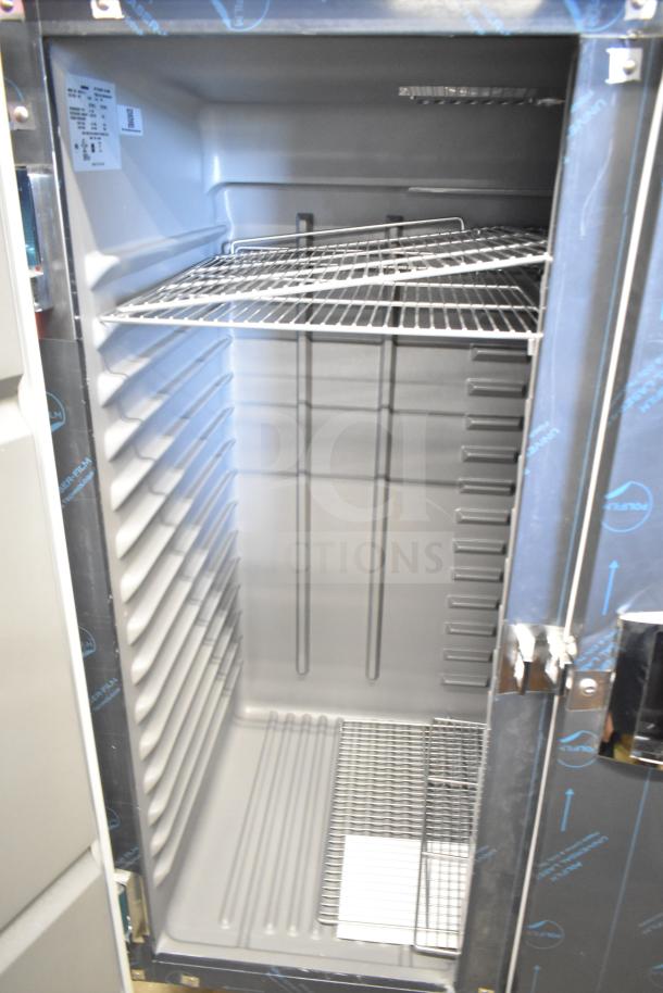 BRAND NEW Delfield 6051XL-S commercial 2-door cooler, scratch and dent model, 115V, 1 phase, interior shelving visible.