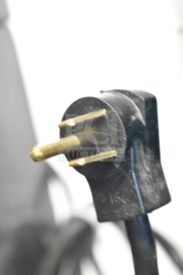 Close-up of a power plug for the Delfield 6051XL-S commercial cooler, 115 volts, brand new, scratch and dent condition.