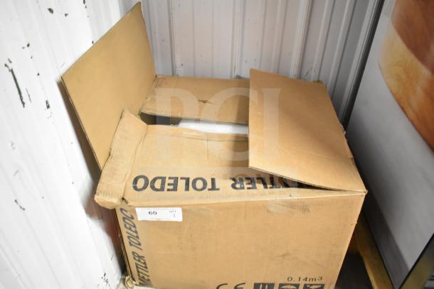 Mettler Toledo commercial countertop scale in open box, tested and working. Box labeled with Mettler Toledo brand.