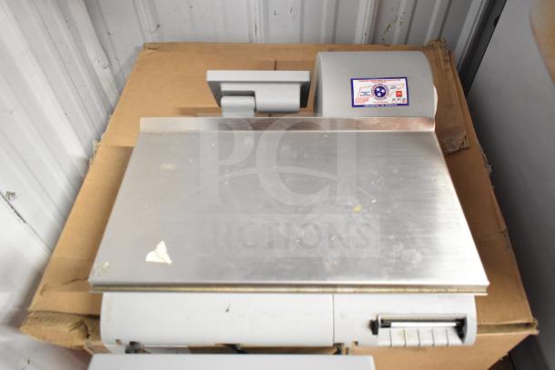 Mettler Toledo commercial countertop scale with stainless steel surface, tested and working, minor surface marks visible.