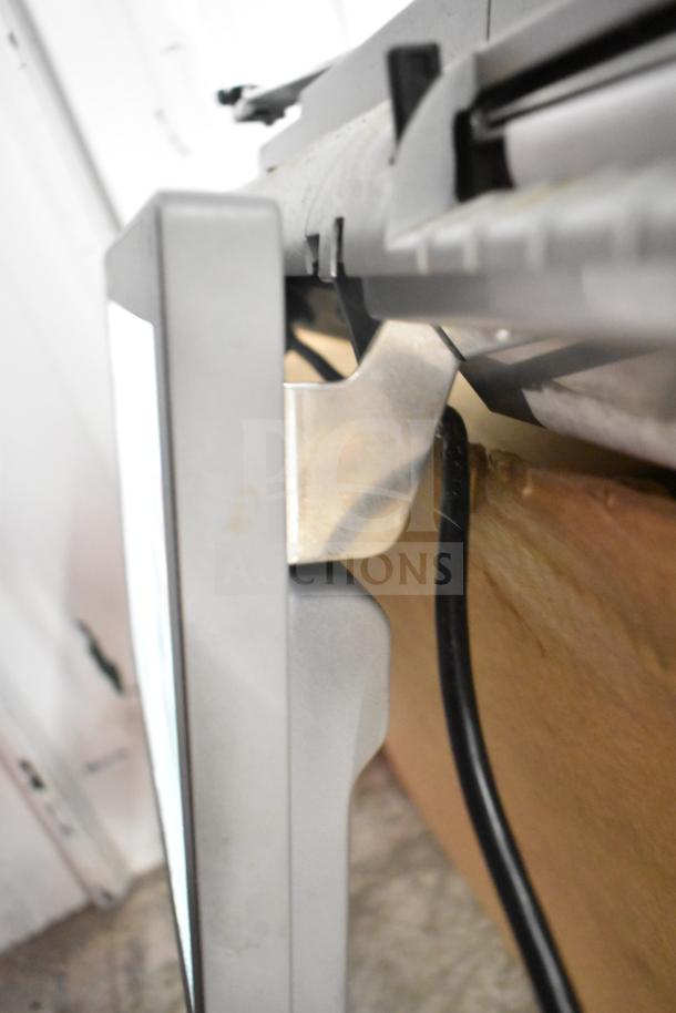 Mettler Toledo Commercial Countertop Scale, grey, in working condition, showing side view with visible power cord.